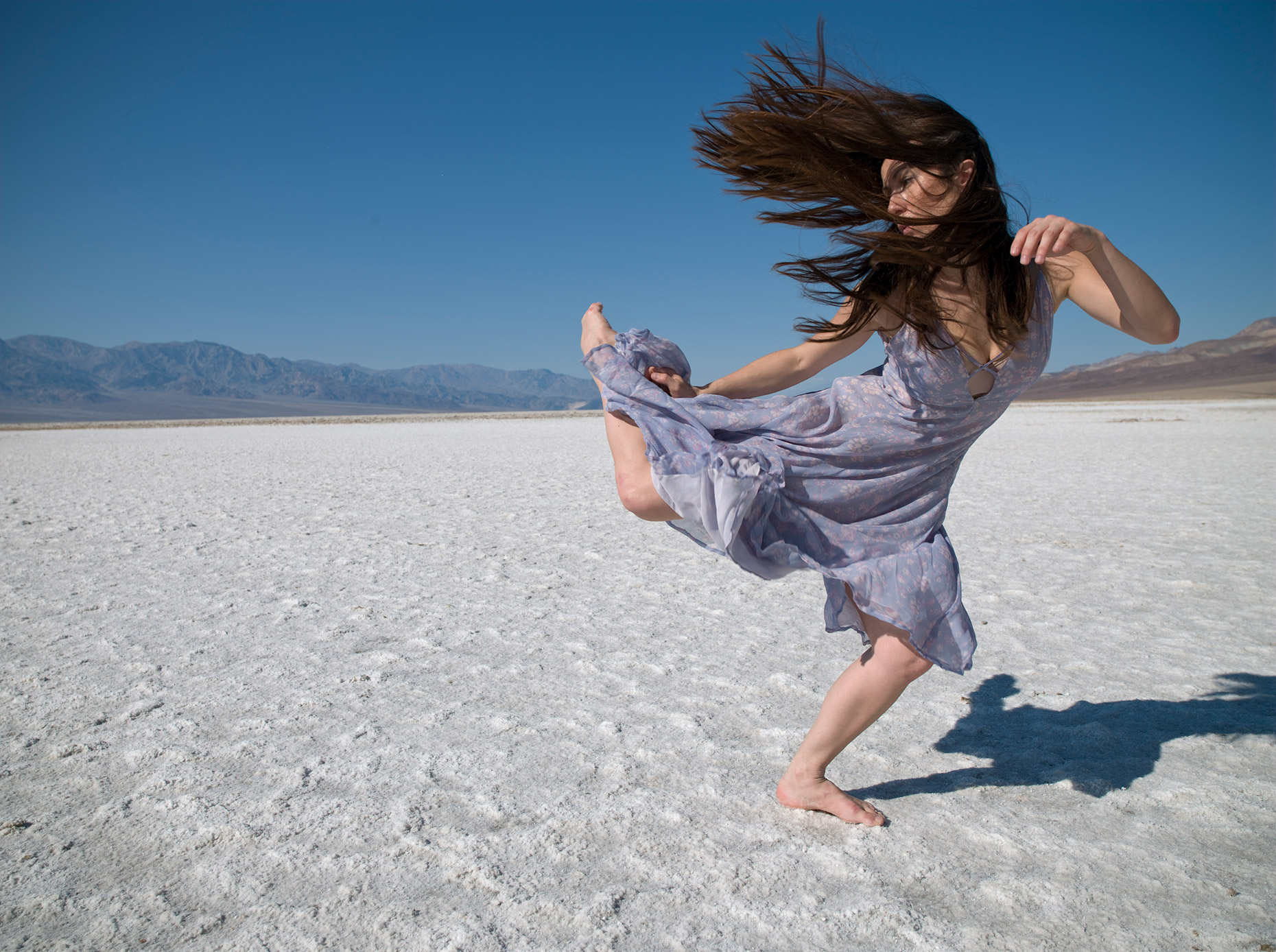 Dancer in a windy Death Valley dancing in the wind.